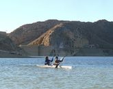 Kayaking in front of Hanna Lake Bridge Wall